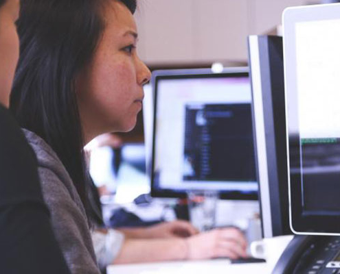 two women working on same computer screen